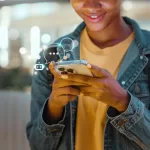 Woman wearing a yellow shirt talking to a chatbot