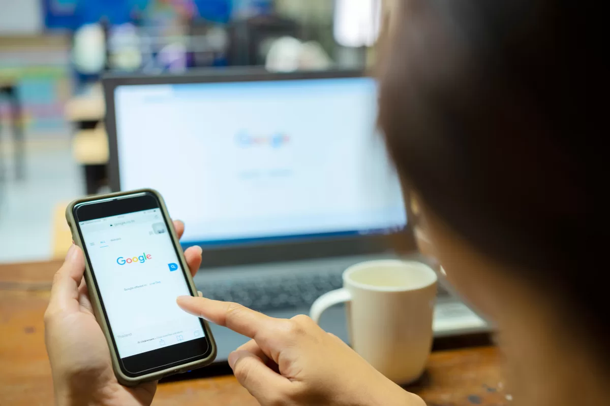 Woman searching something on Google using her cellphone 