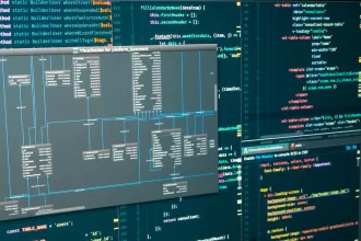 Database schema visualization displayed on a computer screen alongside source code for back-end development and integration testing.