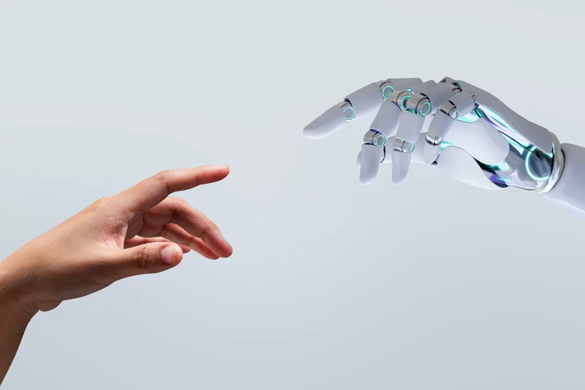 Human hand reaching towards a robotic hand, symbolizing the connection between humans and artificial intelligence.