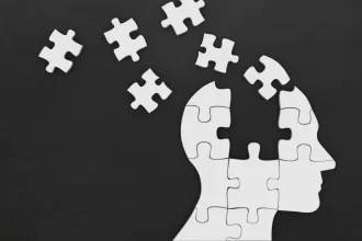 Puzzle pieces forming a human head, representing the concept of memory in AI agents.