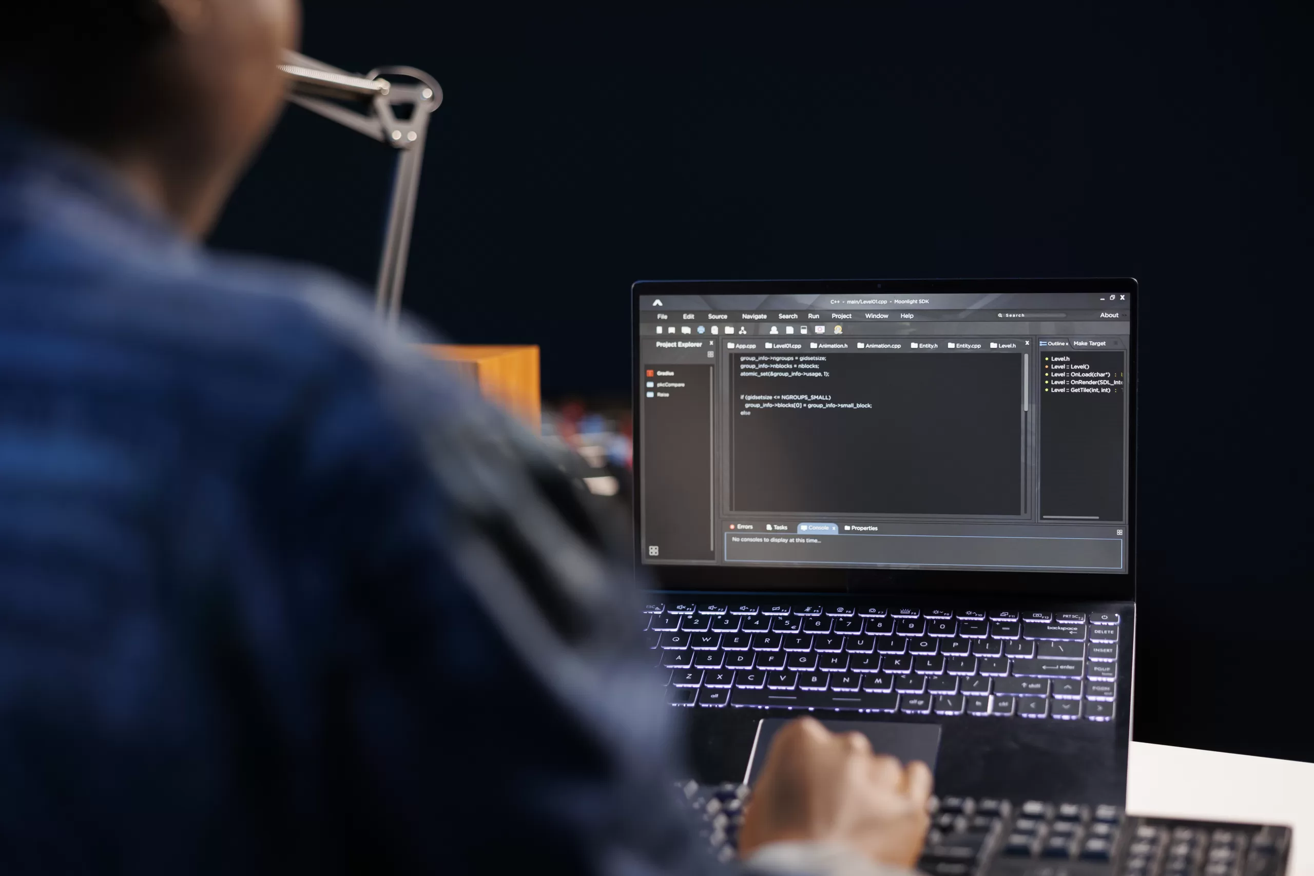 Developer writing code on his black laptop 