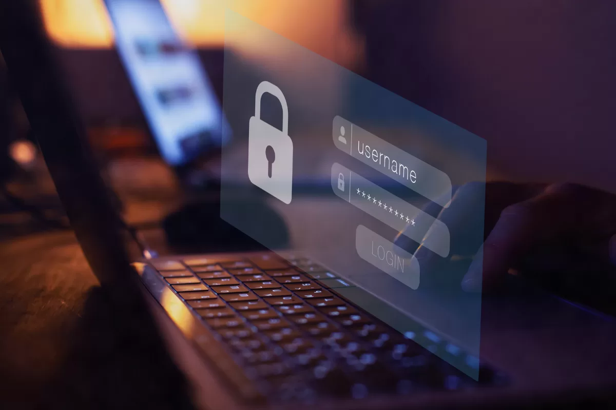 A laptop open displaying a digital login interface with a floating white padlock icon, symbolizing data security and protection against web application breaches.